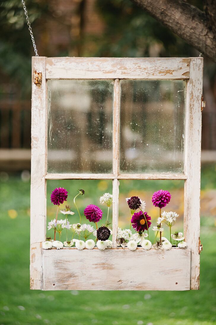 Dahlias and scabiosas in fuchsia, white and dark purple were planted in the hanging window boxes at the ceremony.