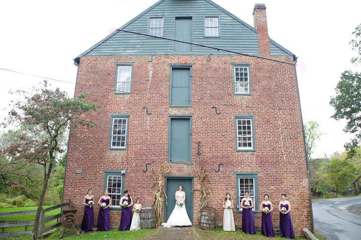The bridesmaids wore strapless, floor-length dresses in deep purple that were perfect for the fall weather and the rustic setting.