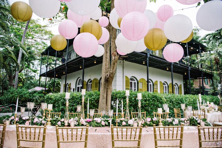 The head table was decorated with different sized ivory, pink and gold lanterns in addition to garlands, mercury glass and candles.