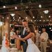Bride and Groom Cutting Into Wedding Cake Under String Lights