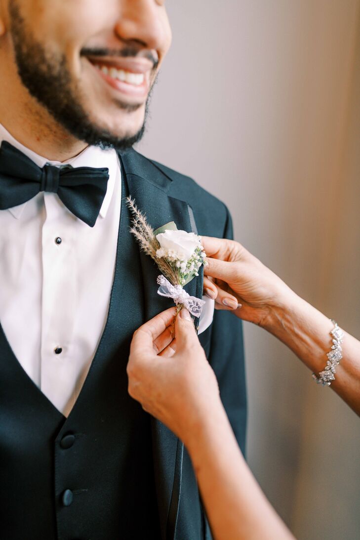 Groom Getting Boutonniere Pinned to His Tuxedo Lapel