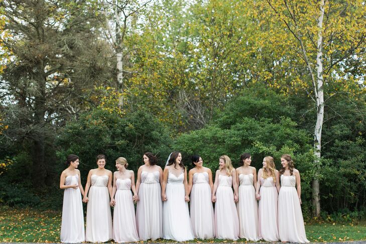 Jenn's nine bridesmaids wore the same strapless, floor-length, sweetheart neckline Jim Hjelm dress in three different shades. "It’s a two-toned dress so the slight color change just gave each three girls an ever so slight difference that I really loved," she says.