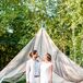 Keeping with the event’s low-key feel, Dor sported a light natural-colored suit, pale blue shirt and suede oxfords for his walk down the aisle. The light palette allowed his bright pink boutonniere to pop, adding a hint of playfulness to his wedding day look.