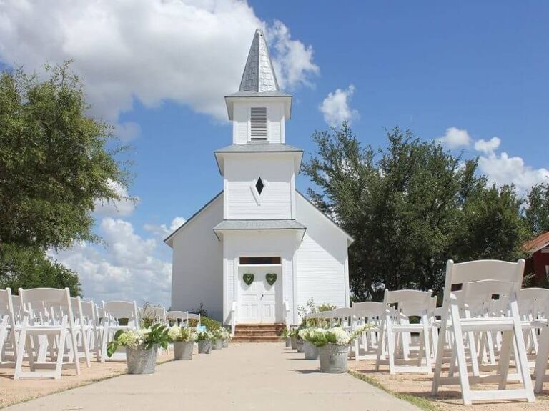 Outdoor ceremenoy venue in front of small white chapel at Star Hill Ranch in Austin, Texas
