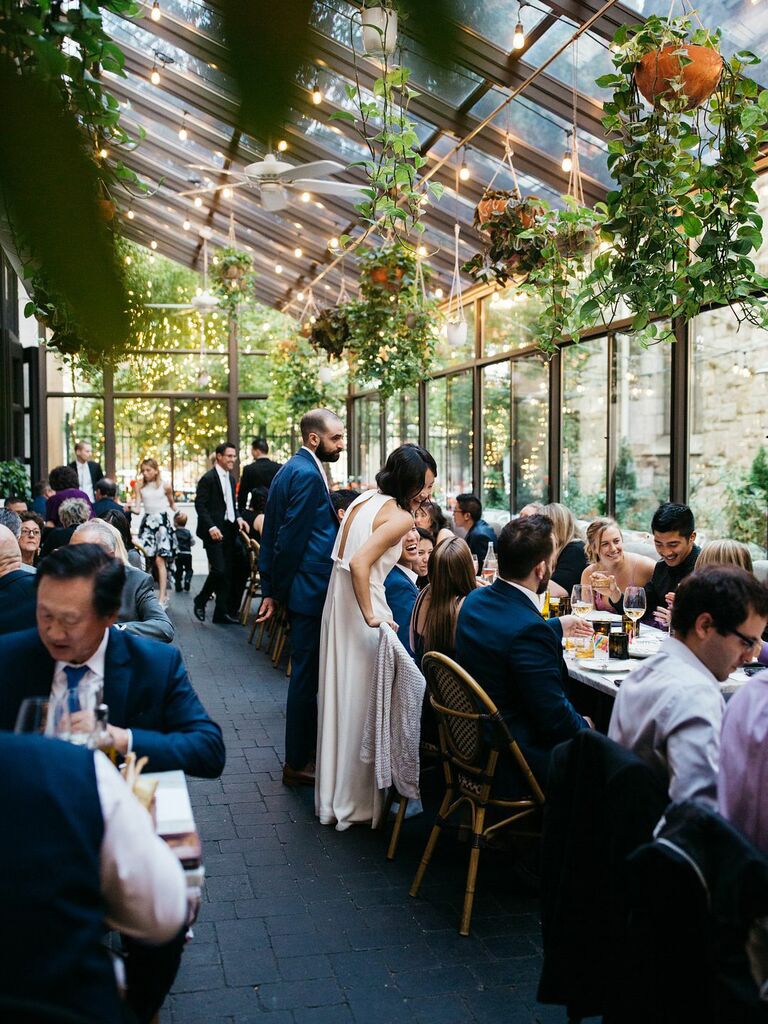 Bride wearing white two-piece set at rehearsal dinner