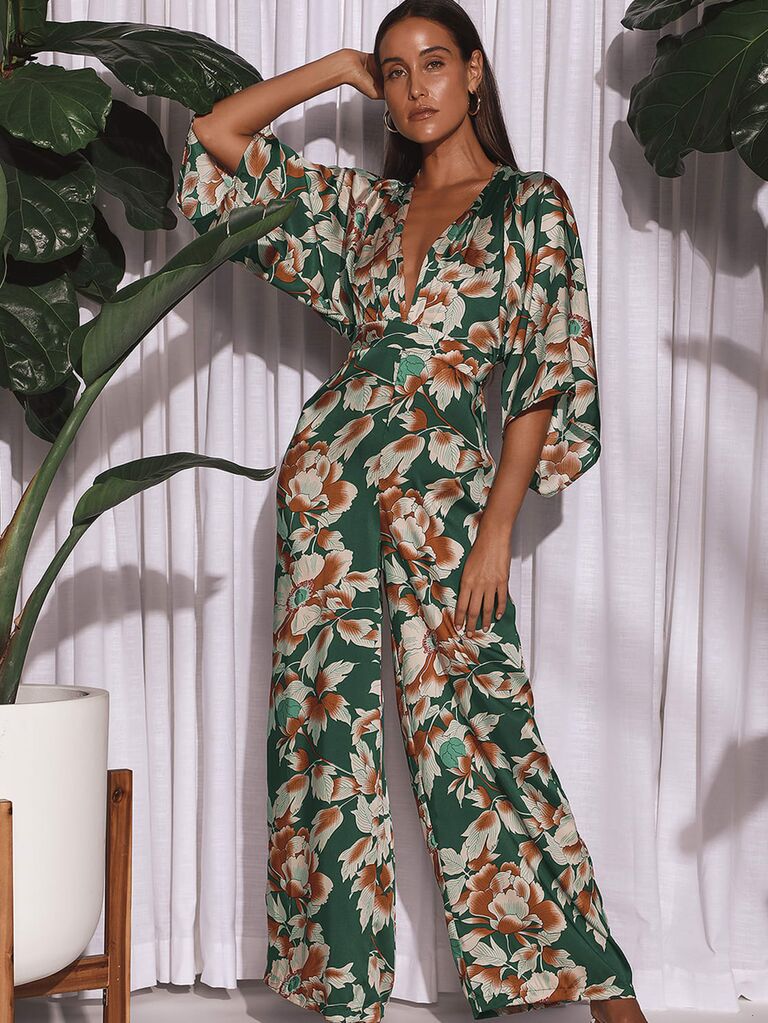 Model wearing floral jumpsuit with long sleeves and V-neckline