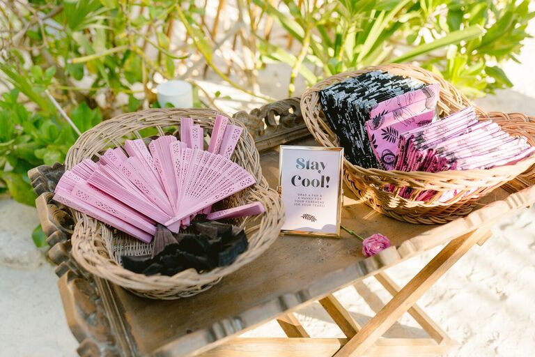 Pink and black fans and handkerchiefs for beach wedding guests