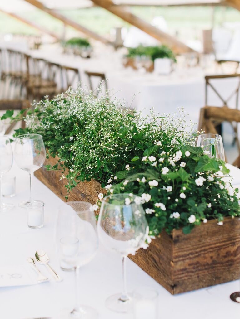 low wedding centerpiece with greenery and wooden box vessel