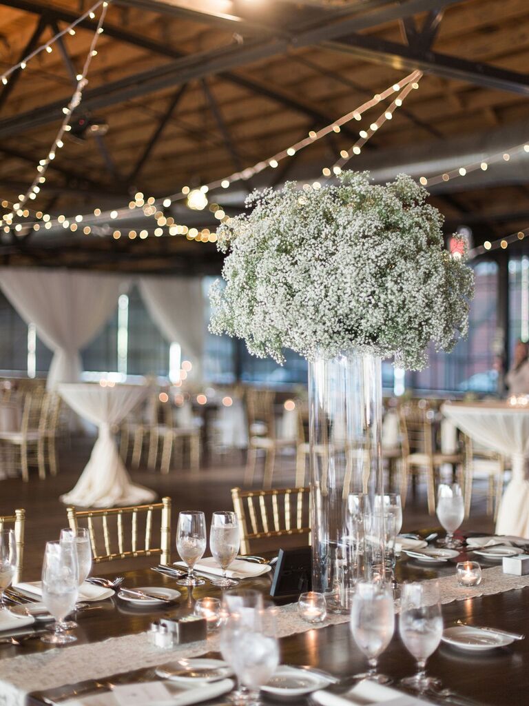 simple tall wedding centerpiece with white baby's breath cluster in glass cylinder vase