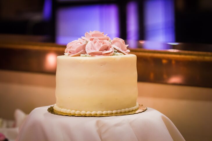 "For dessert, we had a small cutting cake made and decorated by Whole Foods," Marisa says. "It was a simple white cake with pastry cream filling, topped with cream cheese frosting. Simple and elegant small, pink roses topped the cake."