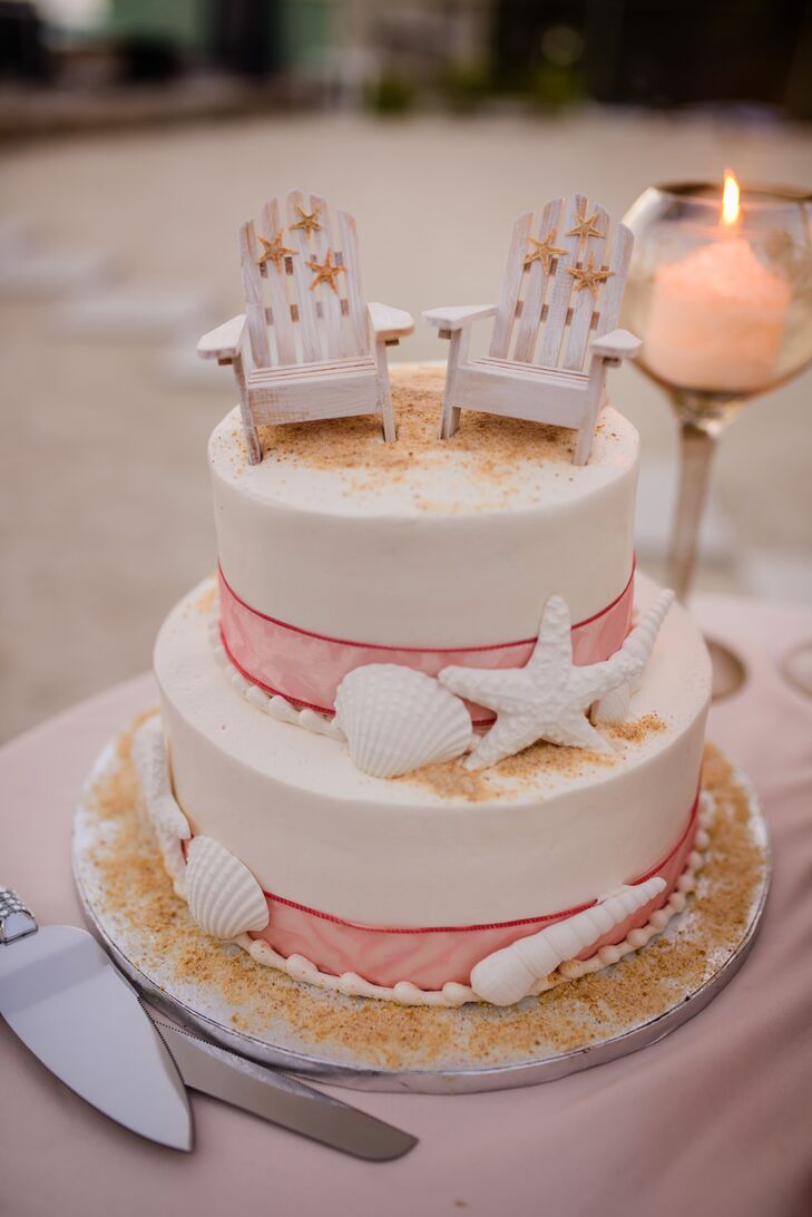 The couple chose a two-tier wedding cake from Publix decorated with pink ribbon, white seashells, white adirondack chairs and tan details resembling sand.