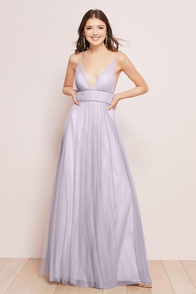 Model wears a pastel purple gown. 