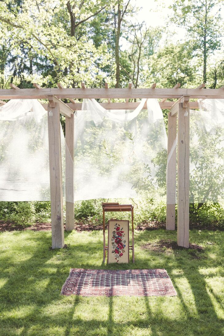 The couple let their friends have free rein in designing the ceremony decor. “I knew I wanted my great-grandmother's needlepoint, our close friends' rug and the beautiful dream catcher made by my bridesmaid Jane,” Lauren says. “Other than that, I told them to try to have fun and make something beautiful.” Lauren and Paul absolutely loved how it turned out, with her grandmother’s needlepoint roses served as the main accent for the couple’s altar.