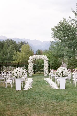 All-White Ceremony Decor With White Floral Arch