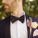 Brandon wore a custom dark blue tuxedo by Tiger of Sweden with black lapels and a black bow tie. His boutonniere was made up of an ivory peony and a pink orchid.