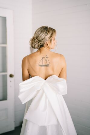 Bride With Updo and Tattoo Wearing Wedding Dress With Bow
