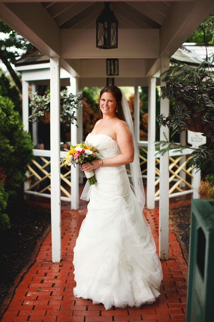 Marisa was able to dance the night away in her strapless ruched modified fit-and-flare dress with a tulle overlay and lace appliques. She added a handmade belt from Etsy for a vintage finish.