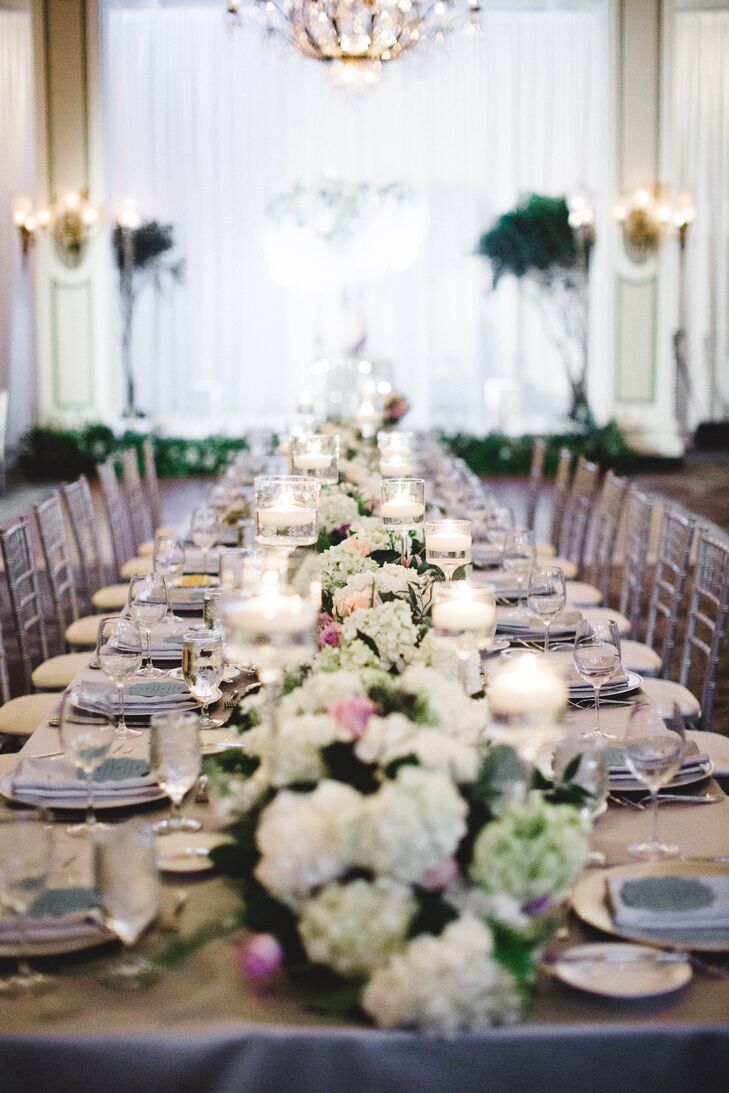 “The reception was styled from an idea I had of the centerpieces growing from tables sprinkled with stardust, along with a visit I had to the Atlanta Botanical Garden,” Rachel says. Tables were adorned with satin silver blue linens draped with sequined overlays. “I loved how they sparkled in the candlelight,” Rachel says. Table settings included silver chargers with white china and matching satin napkins.