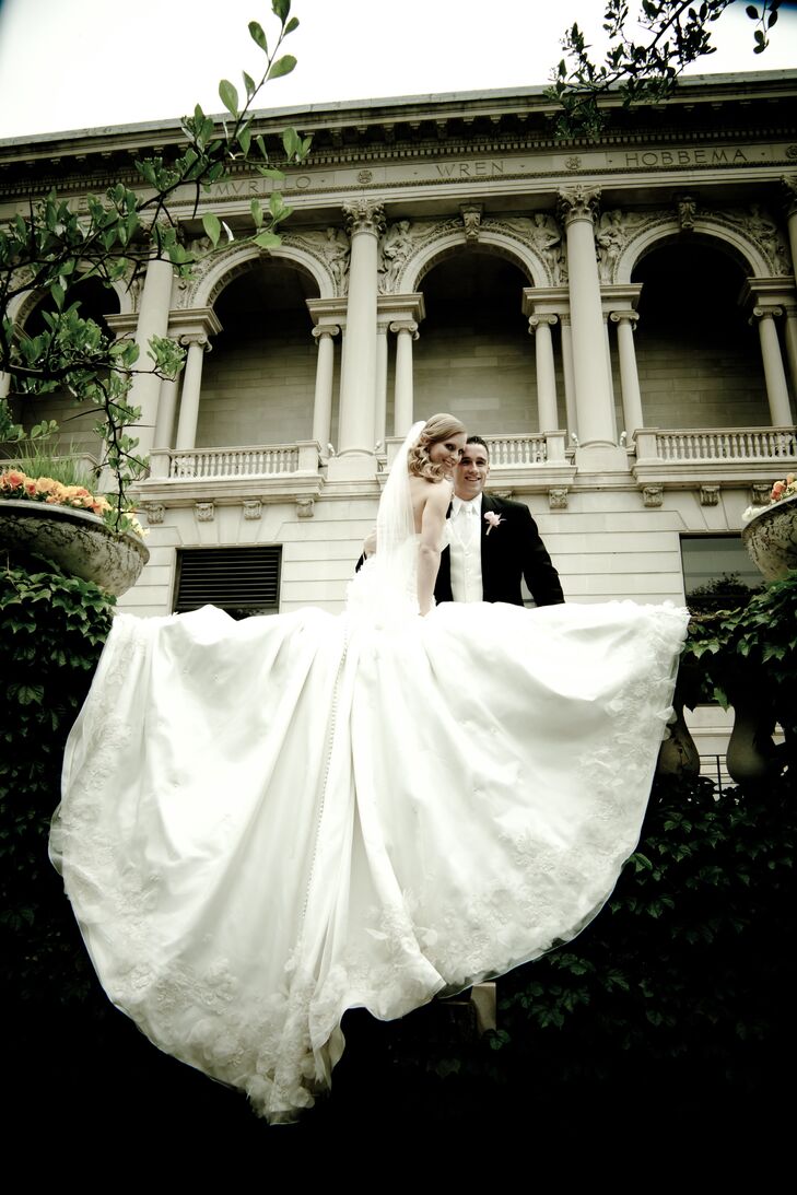 The bride designed her own wedding gown, made of silk organza and detailed with French Alencon lace, hand-cut silk fabric petals, Swarovski crystals and pearl spray. The gown's crowning glory was its nine-foot train.
