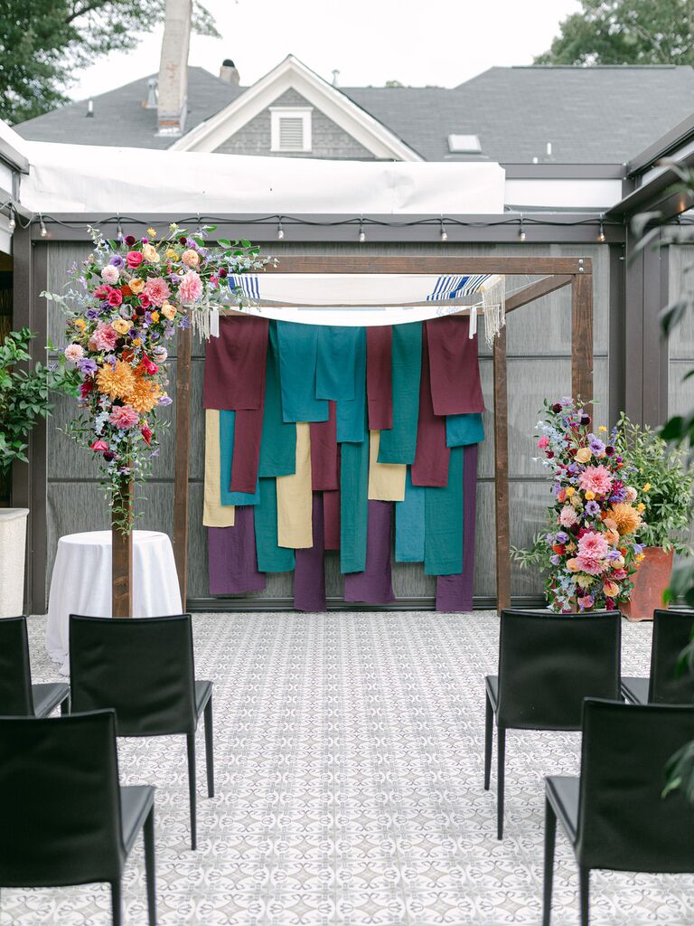 Chuppah with jewel-tone fabric backdrop