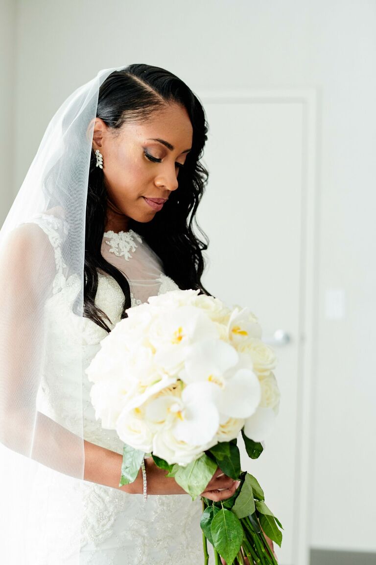 Bride holding elegant white wedding bouquet