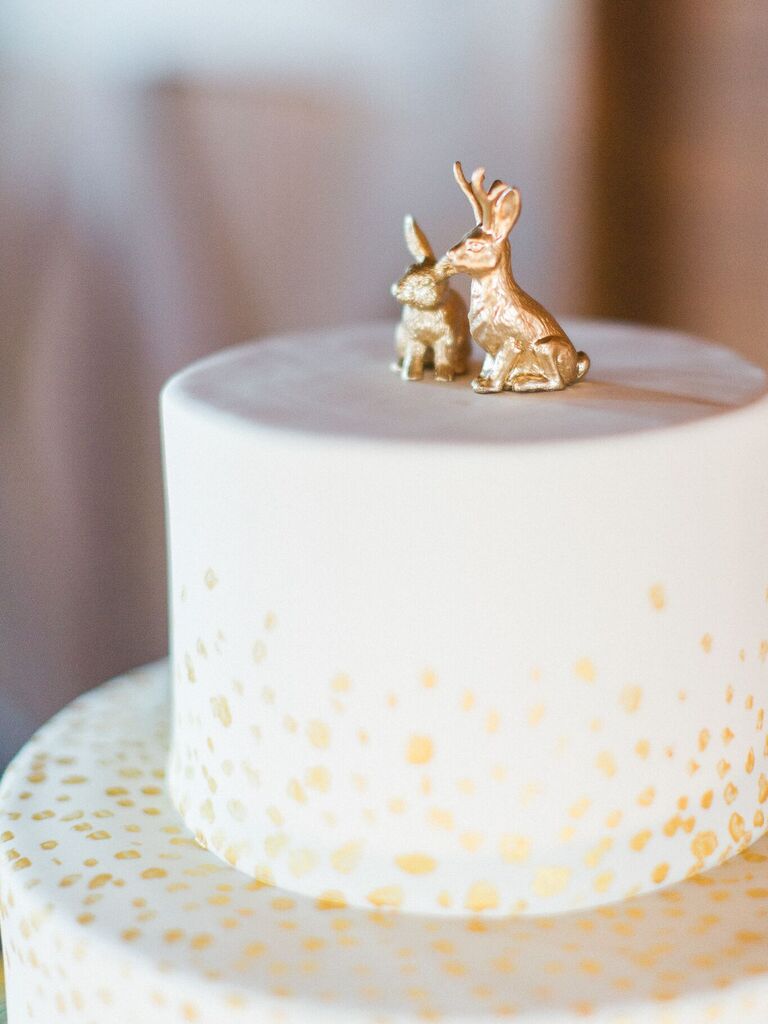 Two golden rabbit wedding cake toppers. 