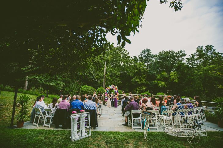 Kim and Ginny were married in a beautiful, secular ceremony on a stone patio at dusk. Greenery surrounded them on all sides on the stone patio at Old Anglers Inn.