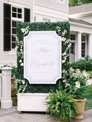 Blue-and-White Wedding Welcome Sign on Faux Floral Wall