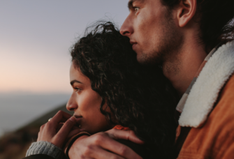couple looking at view from mountain 