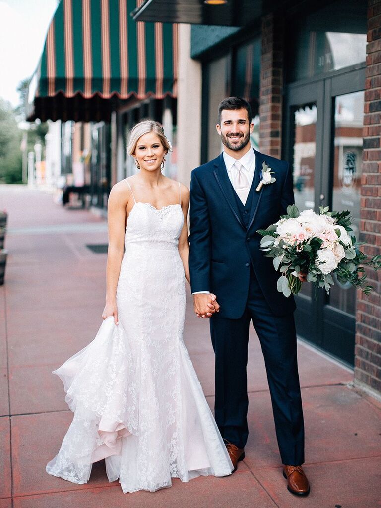 bride and groom holding hands on the street