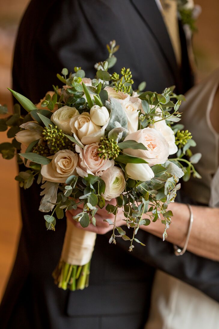 Katherine's bouquet consisted of soft pink roses mixed with eucalyptus. Bill's boutonniere included the same florals.