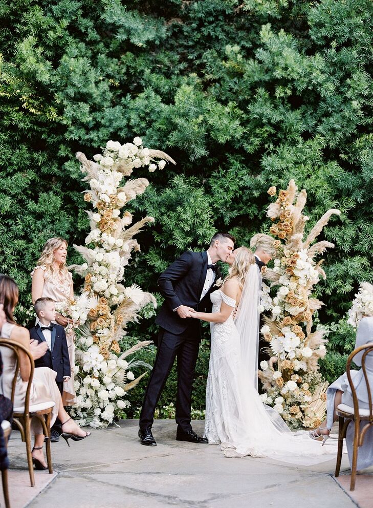 Couple Sharing First Kiss During Ceremony at Franciscan Gardens in San Juan Capistrano, California