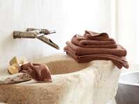 Set of colorful bath sheets and towels on bathroom sink