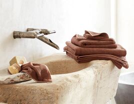 Set of colorful bath sheets and towels on bathroom sink