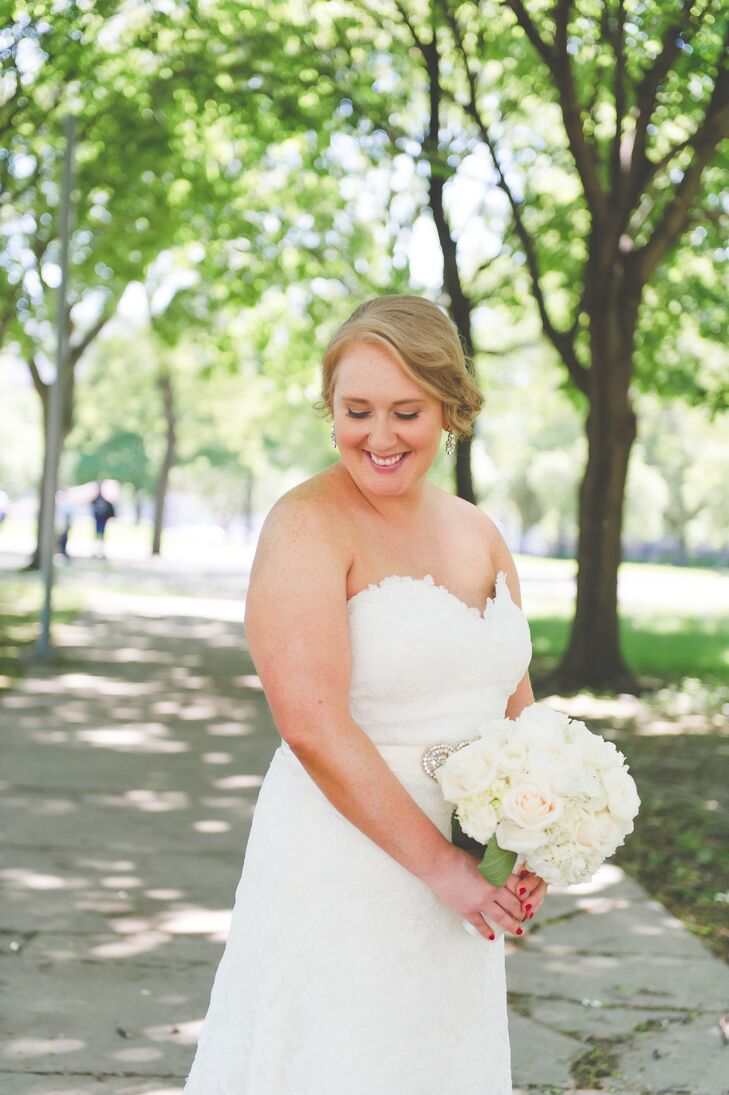 The bride opted for a sideswept updo and elegant drop earrings to go with her white lace Eugenia Couture wedding dress.