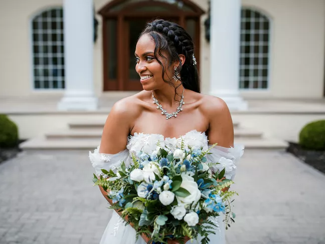 Bride in off-the-shoulder dress holding bouquet 