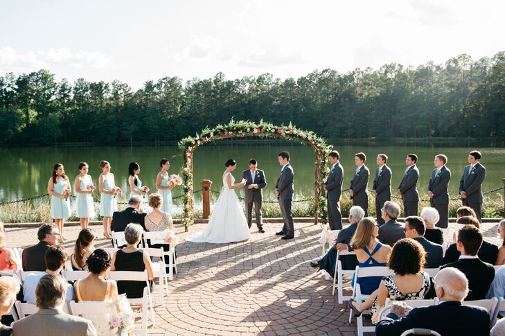 The calm waters and thick green forests of Angus Barn Lake provided the backdrop for Katharine and Nate’s vows. Bunches of pastel blooms and a lush green garland gave the ceremony space a polished feel.