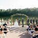 The calm waters and thick green forests of Angus Barn Lake provided the backdrop for Katharine and Nate’s vows. Bunches of pastel blooms and a lush green garland gave the ceremony space a polished feel.