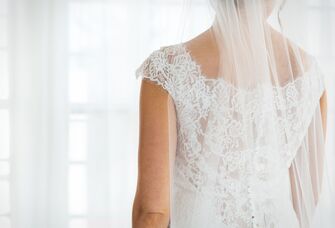 Bride in wedding dress looking away from the camera. 