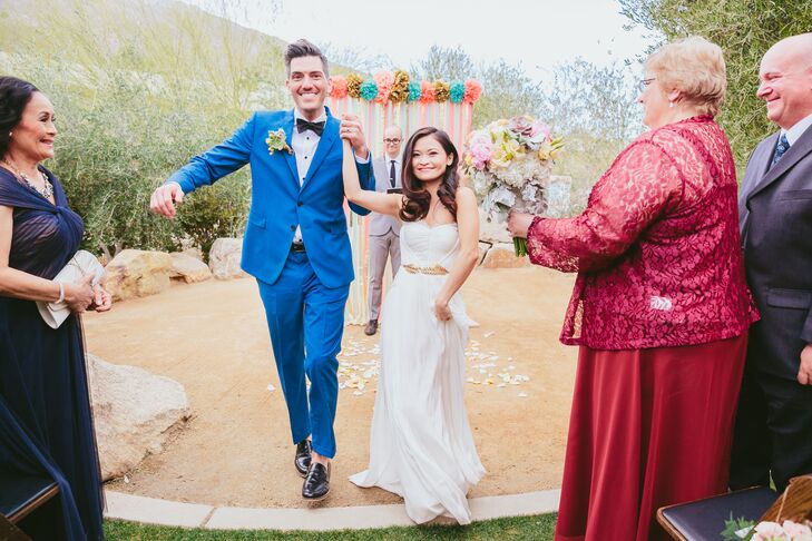 Mai's white Maria Lucia Hohan dress embodied an elegant, romantic style to walk up the aisle in. The corset-styled bodice had wrapped layers of tulle around its shape, and a gold-leaf belt added a touch of glam to the getup.