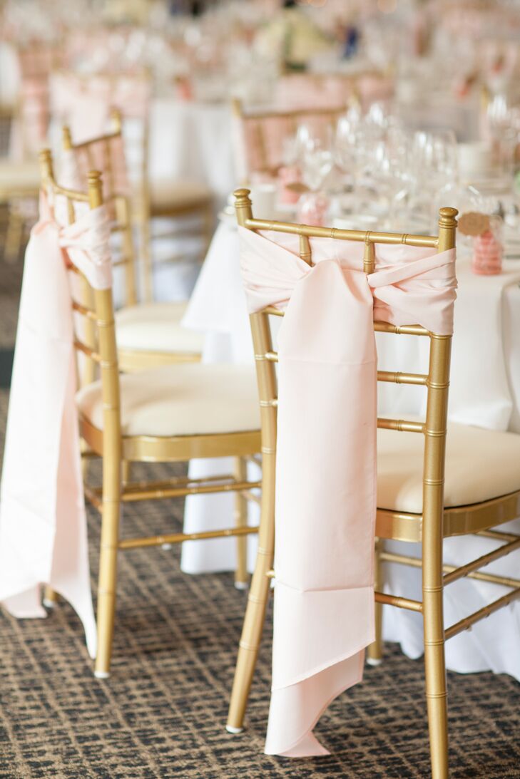 Gold chiavari chairs were accented with pale pink sashes for a romantic, elegant feel.