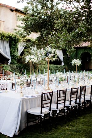 Formal Outdoor Reception with Tall Gold Centerpieces and Blue Taper Candles