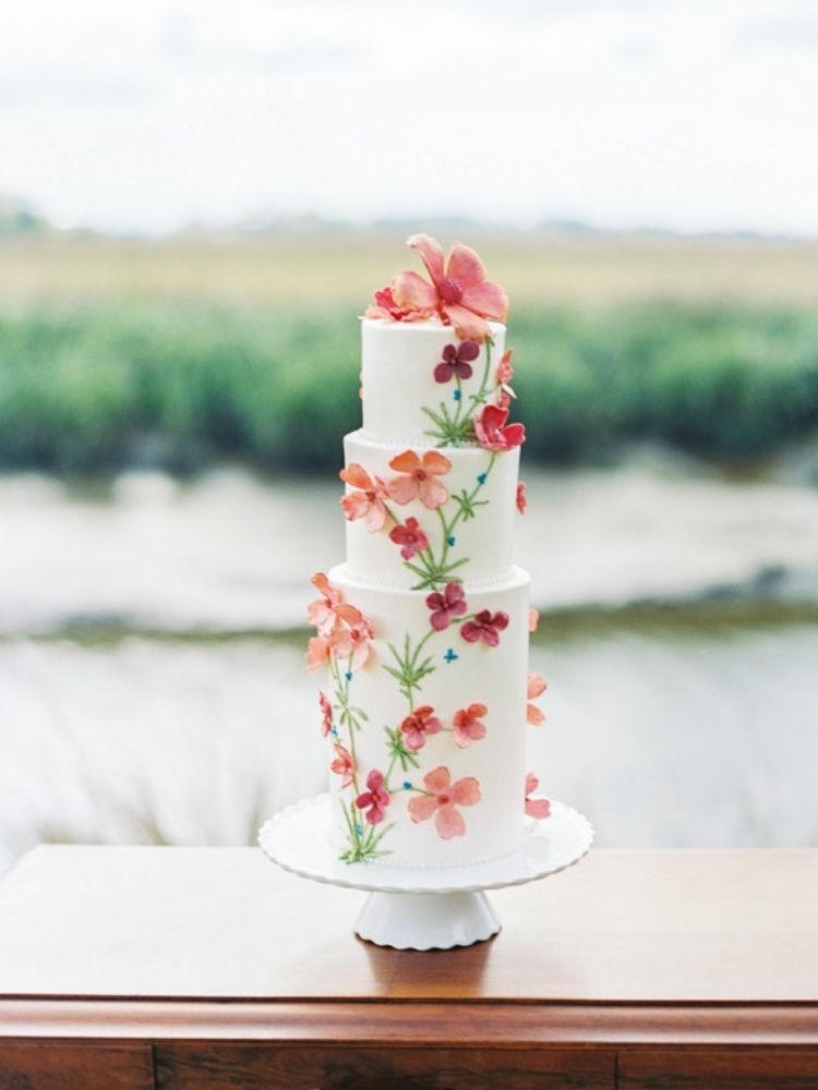 three-tier spring wedding cake with pink flowers