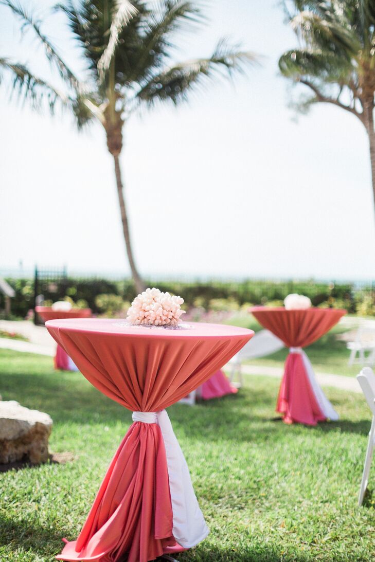 Guests who stayed outside for cocktail hour were greeted with all-coral decor. Draping the tables were coral linens, and each accent was topped with real coral in a matching hue. How cool is that?