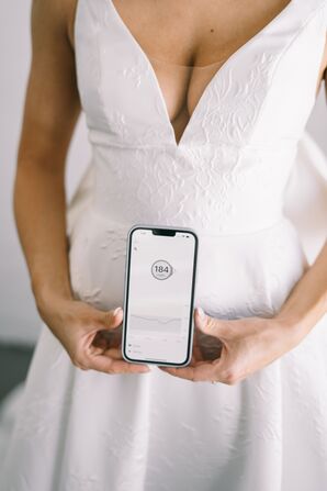 Diabetic Bride Holding Phone With Glucose Tracking App