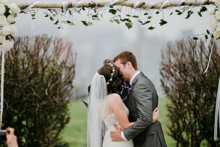 Janel looked nothing short of classic as Charlie took her in his arms for their first kiss. Highlighting the short hairstyle he loves, she wore a sheer white veil from a boutique on the Jersey Shore. Delicate beading covered the trim, matching the white beads on her lace bodice and illusion back.