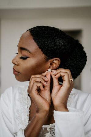 Bride Putting on Earrings While Getting Ready for Wedding in Durham, North Carolina