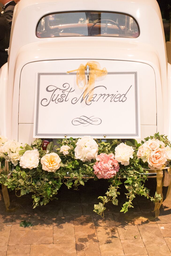 At the end of the night, Megan and Bobby made their exit from the Dallas Country Club in Dallas, Texas, in the back of a vintage car decorated with a garland of ivy and oversize roses.