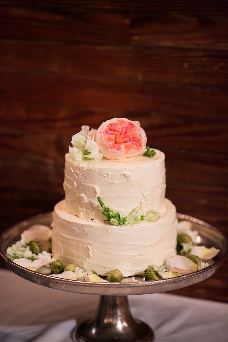 More than a few desserts were available for Caitlin and Mike's 190 guests in Laudholm Farm’s barn. The couple chose a two-tier confection topped with a blush pink garden rose. They also served mini cupcakes and tartlets in different flavors. After dessert, the couple finished their night by dancing to a live band.