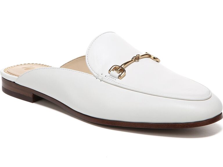 White slip-on mule with gold accents and a sleek brown heel